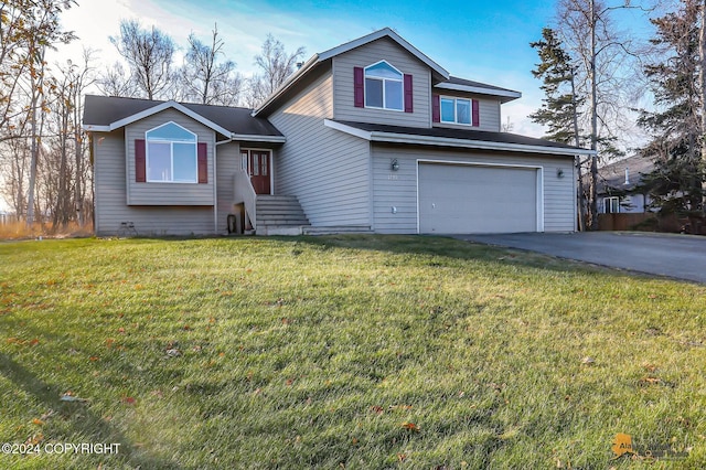 view of front of property with a front yard and a garage