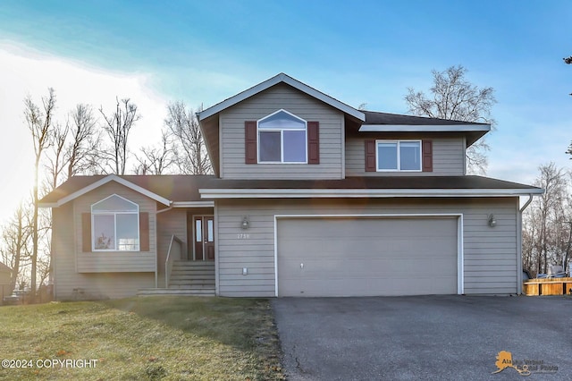 front facade featuring a front yard and a garage