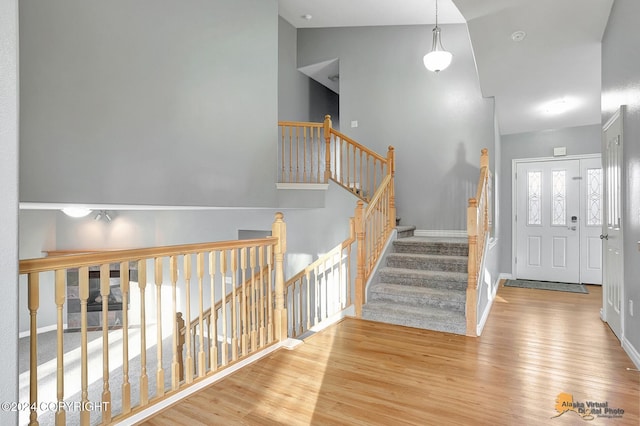 entryway featuring light hardwood / wood-style floors and high vaulted ceiling