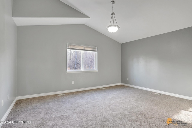 empty room with lofted ceiling and carpet