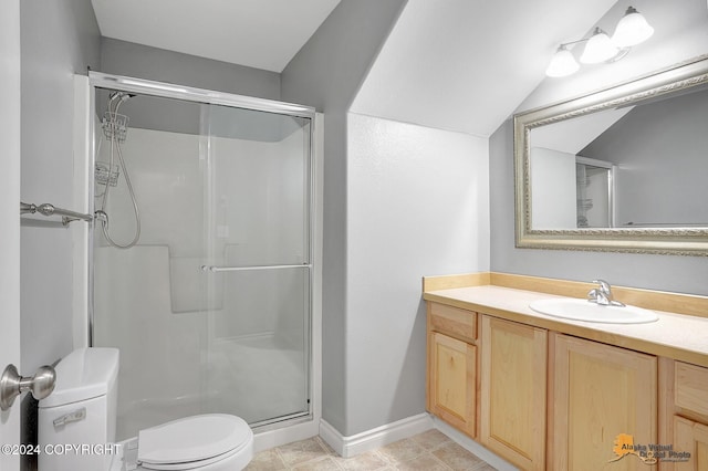 bathroom featuring vanity, tile patterned floors, toilet, and walk in shower