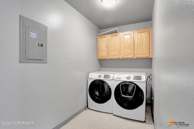 laundry room featuring cabinets, washer and dryer, and electric panel