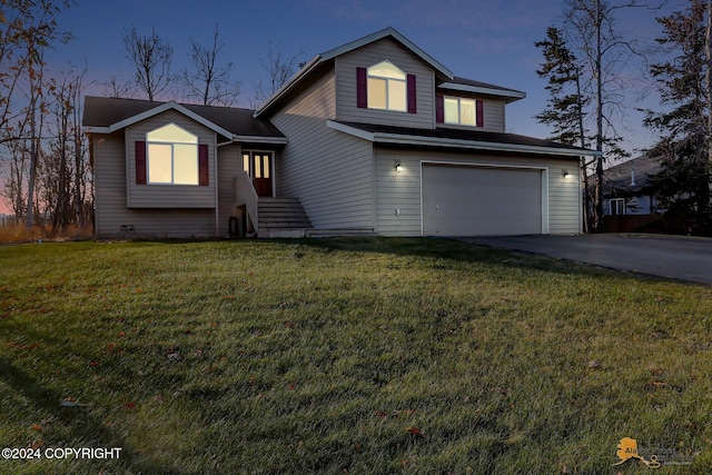 view of front of house featuring a lawn and a garage