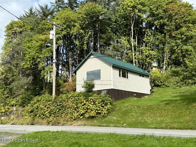 view of home's exterior with a lawn