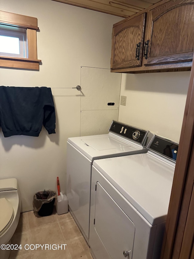 laundry room with washer and dryer, laundry area, and light tile patterned floors