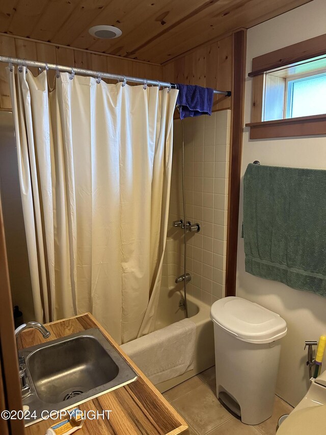 bathroom with toilet, wood ceiling, a sink, tile patterned flooring, and shower / bath combo with shower curtain