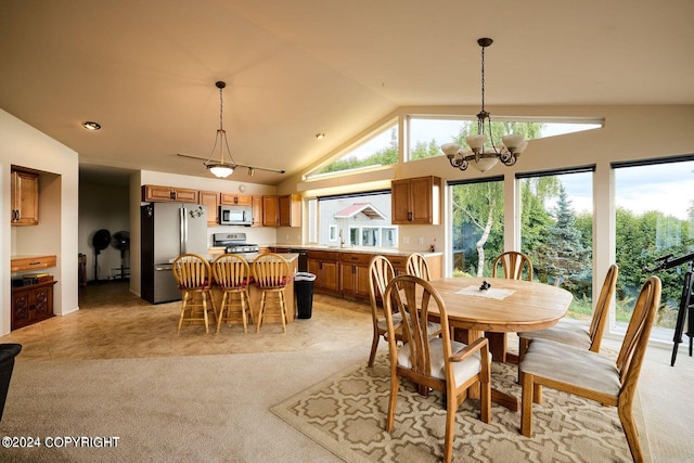 carpeted dining space with vaulted ceiling, sink, and a notable chandelier