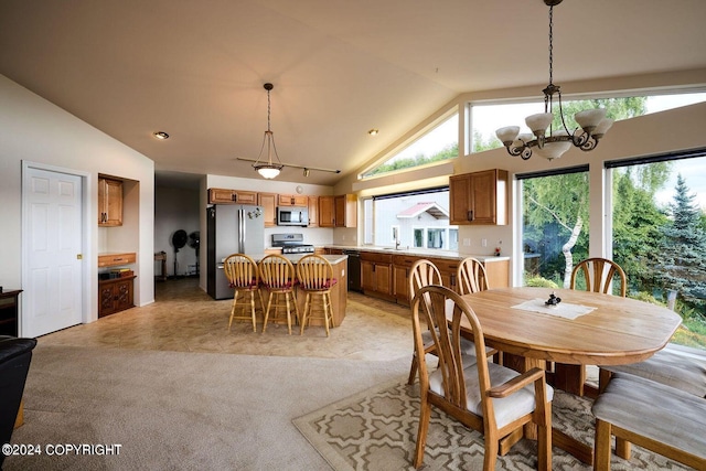 41385 Ptarmigan Heights Dr, Homer, AK 99603 - dining room featuring a chandelier, high vaulted ceiling, and light carpet