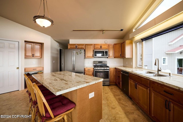 41385 Ptarmigan Heights Dr, Homer, AK 99603 - kitchen featuring stainless steel appliances, a sink, vaulted ceiling, brown cabinets, and light stone countertops