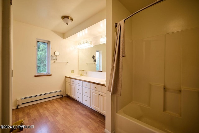 41385 Ptarmigan Heights Dr, Homer, AK 99603 - full bath with a baseboard radiator, double vanity, wood finished floors, and bathing tub / shower combination