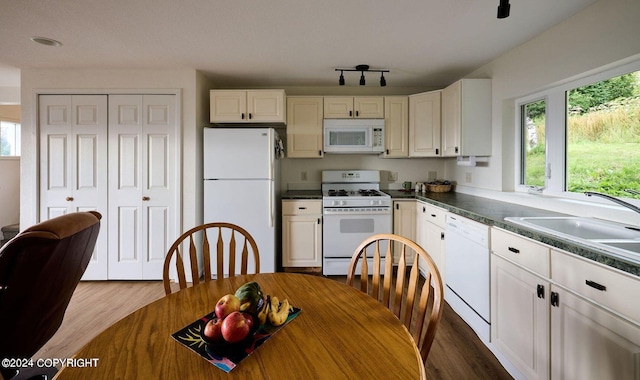 41385 Ptarmigan Heights Dr, Homer, AK 99603 - kitchen featuring white appliances, dark countertops, dark wood finished floors, and a sink