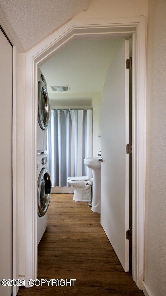 41385 Ptarmigan Heights Dr, Homer, AK 99603 - laundry area featuring stacked washer / drying machine and wood finished floors