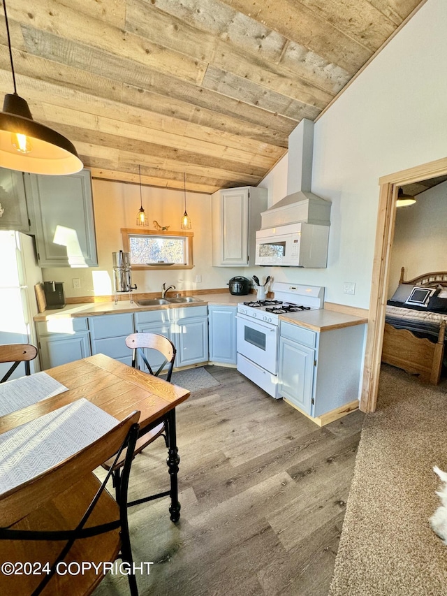 kitchen with sink, white appliances, decorative light fixtures, ventilation hood, and light hardwood / wood-style floors