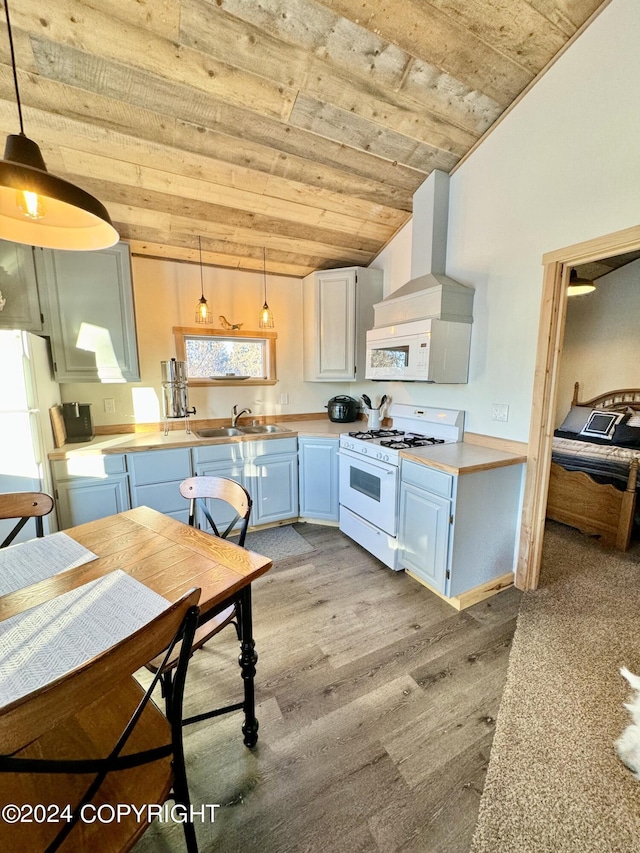 40854 Ruth Way, Homer, AK 99603 - kitchen with light countertops, white appliances, wooden ceiling, a sink, and wall chimney exhaust hood