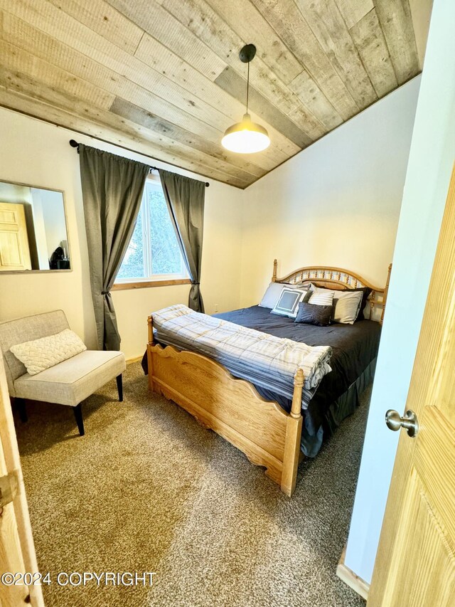 bedroom featuring wood ceiling and carpet