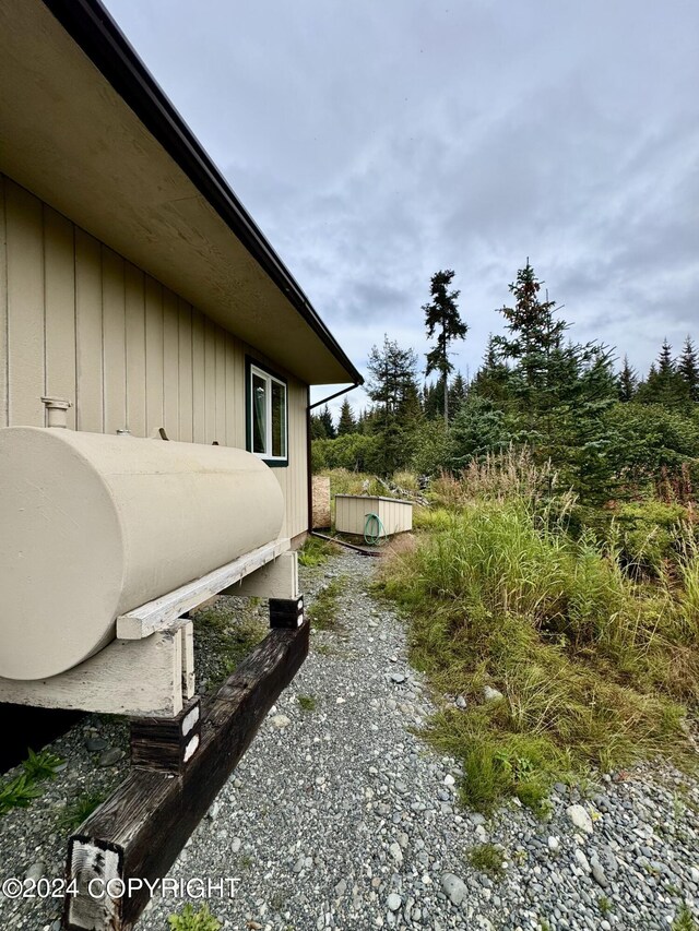 view of property exterior featuring a shed