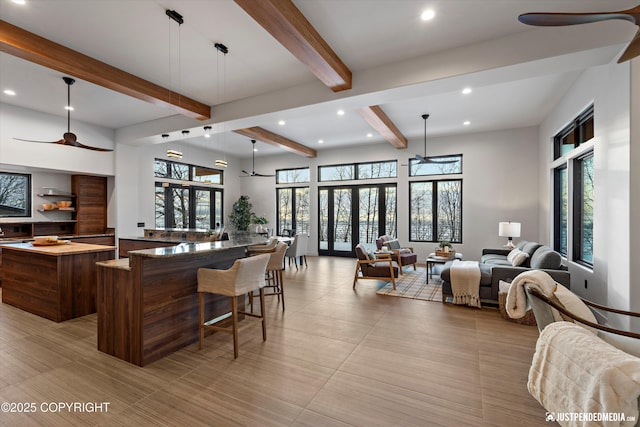 kitchen with beam ceiling, decorative light fixtures, and ceiling fan