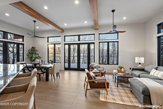 living room with beam ceiling, french doors, and ceiling fan