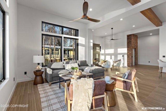 living room featuring ceiling fan and beam ceiling