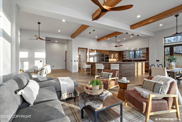 living room featuring beam ceiling and light wood-type flooring