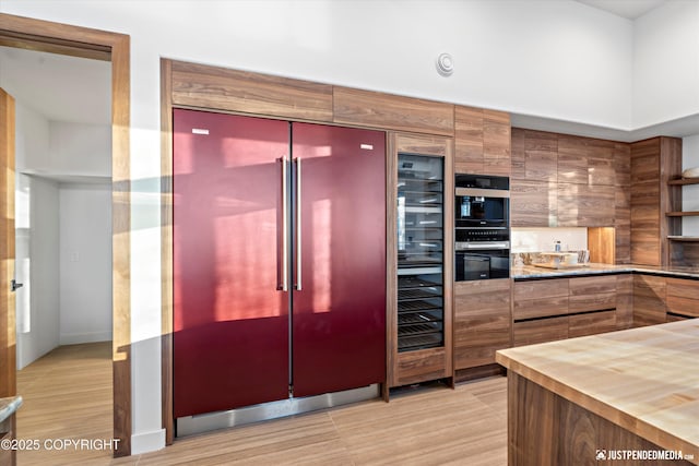 kitchen with double oven and built in refrigerator