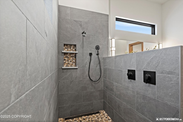 bathroom with tiled shower