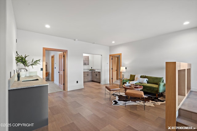 living room featuring light hardwood / wood-style floors and sink