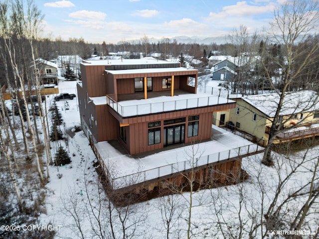 view of snow covered rear of property