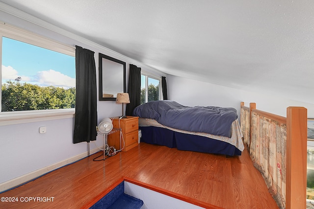 bedroom featuring a textured ceiling and hardwood / wood-style flooring