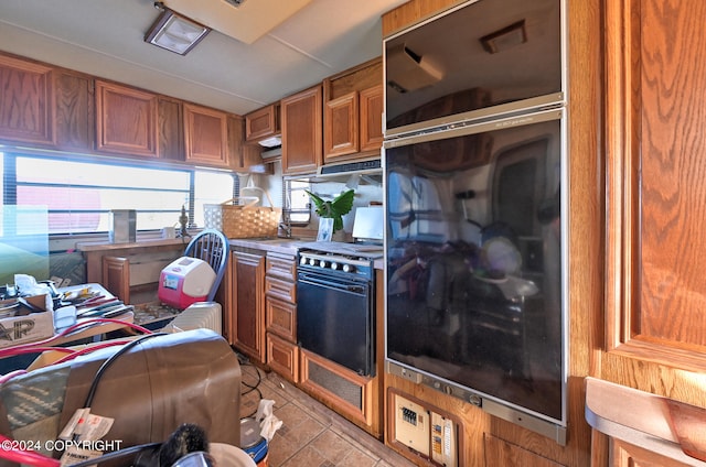 kitchen featuring black / electric stove and light tile patterned floors