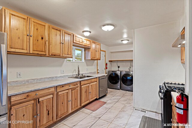 kitchen featuring sink, washing machine and clothes dryer, stainless steel dishwasher, gas range, and range hood