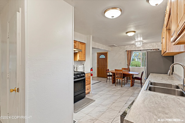 kitchen featuring black gas stove and sink