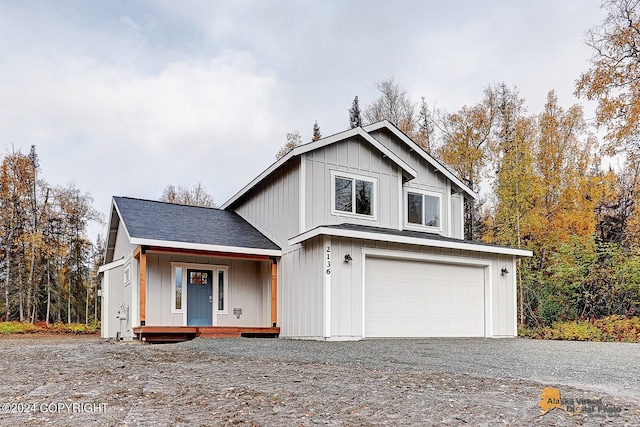 view of front facade with a garage and a porch