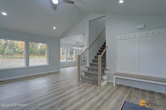 interior space with ceiling fan, light wood-type flooring, and high vaulted ceiling