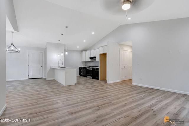 kitchen with white cabinets, ceiling fan with notable chandelier, pendant lighting, sink, and stainless steel electric range oven