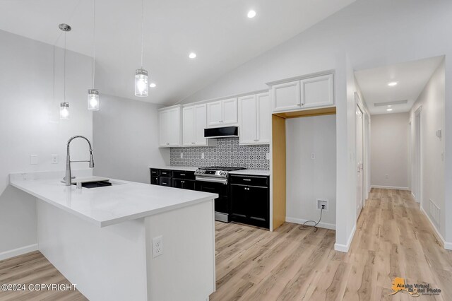 kitchen with white cabinetry, pendant lighting, lofted ceiling, sink, and stainless steel range with electric cooktop