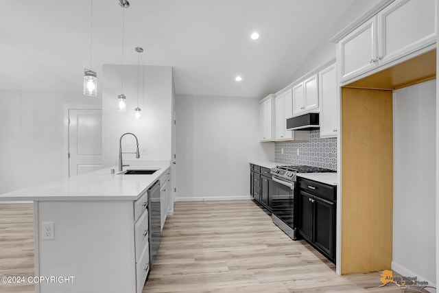 kitchen featuring light hardwood / wood-style floors, sink, white cabinets, appliances with stainless steel finishes, and decorative light fixtures