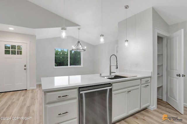 kitchen featuring a chandelier, light hardwood / wood-style floors, white cabinets, lofted ceiling, and decorative light fixtures