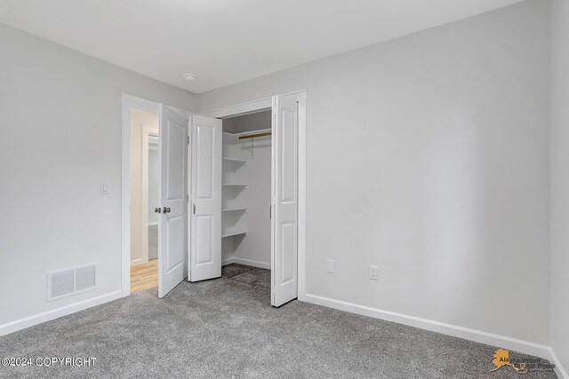 unfurnished bedroom featuring a closet and carpet