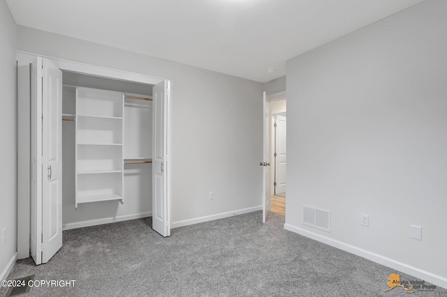 unfurnished bedroom with carpet floors and a closet