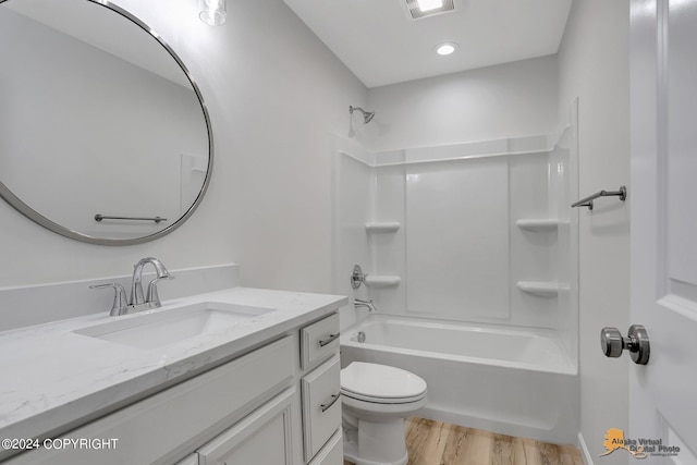 full bathroom with shower / tub combination, vanity, hardwood / wood-style floors, and toilet