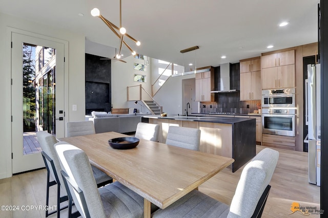 dining area with light wood-type flooring and sink