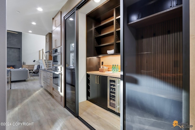 interior space featuring beverage cooler and light hardwood / wood-style flooring