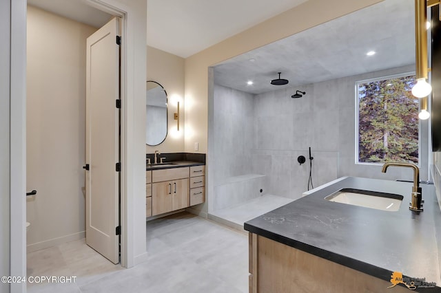 bathroom featuring vanity and a tile shower