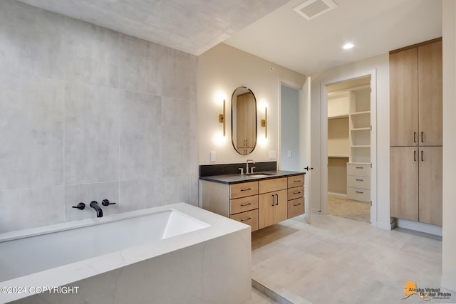 bathroom with vanity and a tub