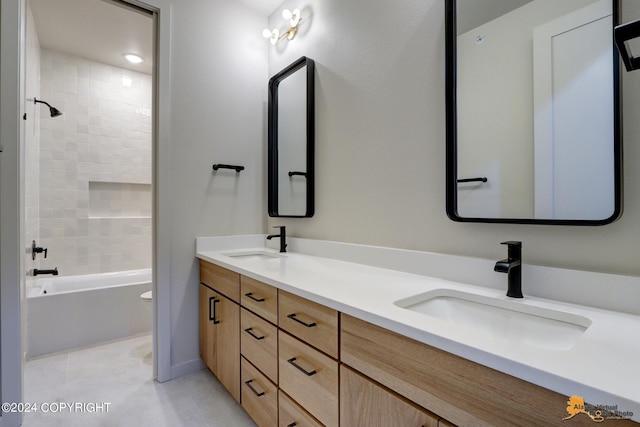 full bathroom featuring tiled shower / bath combo, tile patterned flooring, vanity, and toilet