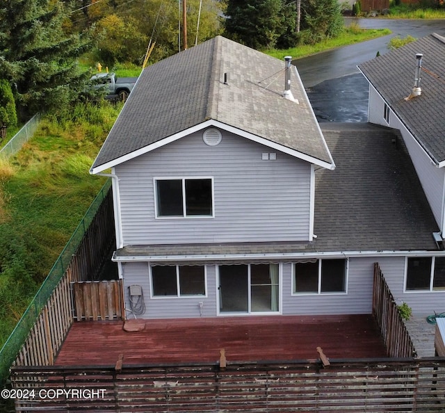 rear view of house featuring a wooden deck