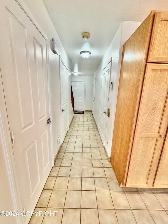 hallway featuring light tile patterned floors