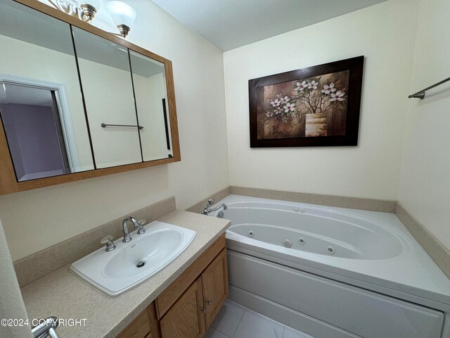 bathroom with vanity, a bath, and tile patterned floors