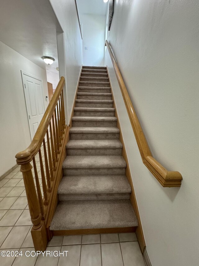 staircase with tile patterned floors